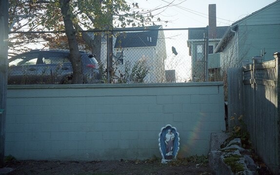 One catholic ornament in a barren urban backyard.